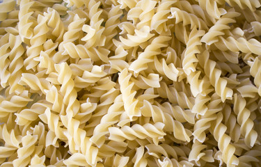 Dry pasta background, healthy food, yellow background