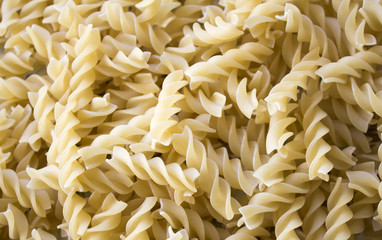 Dry pasta background, healthy food, yellow background