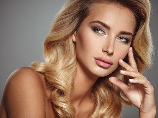 Photo of a beautiful young blond woman with curly hair