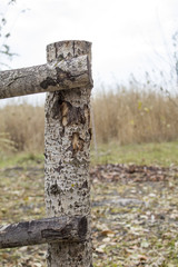 Wooden fence near the river. connection of beams