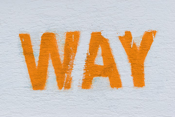 Orange word way written on white wall. Way as sign, background or wallpaper