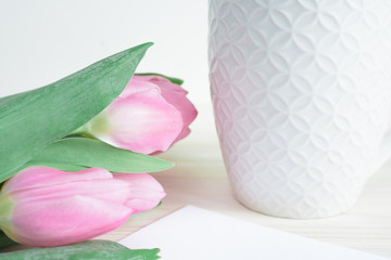 Soft composition with white ceramic mug and pink tulips