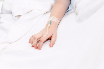 Obraz na płótnie Canvas Little girl hand with IV saline intravenous in hospital