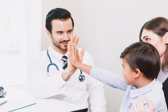Doctor giving hi five with patient boy in hospital.healthcare and medicine