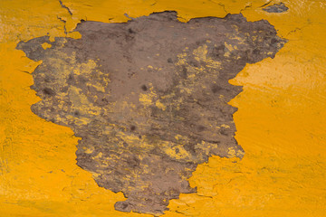 closeup flaky yellow paint wall and gray background