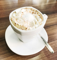 Cup of cappuccino served on table