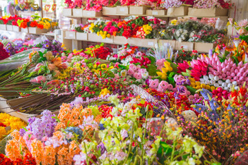 plastic flower shop beautiful colorful fake flora for home decoration.