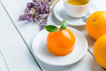 Orange cake on white wooden table