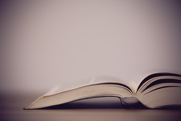 An opened holy bible on a wooden table