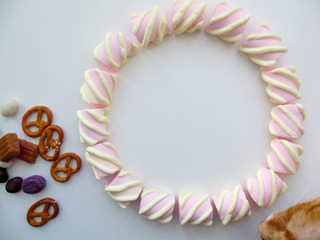 Unhealthy food concept. A lot of sweets and candies background. Close up. Toning effect, copy space. Cat is sniffing	