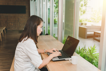 Beautiful woman using laptop at cafe