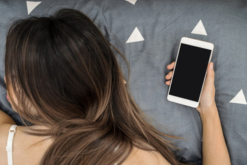 Woman sleeping on the bed with smart phone