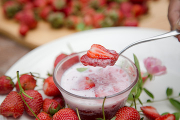 Strawberry milk and rose on wood table