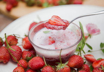 Strawberry milk and rose on wood table