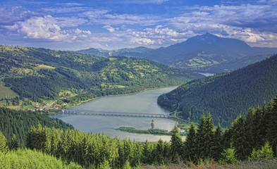 mountain landscape with lake and bridge. Poiana Largului, Romania