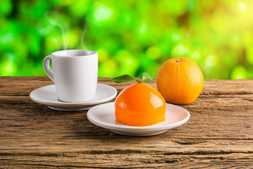 Orange cake on grunge wooden table