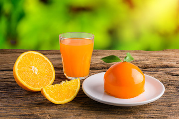 Orange cake and Glass of Fresh Orange Juice on grunge wooden table