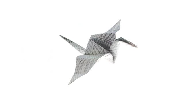 Beautiful heron origami crane animated flying from left to right on a white background. 4K video