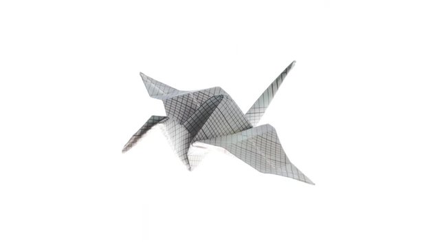 Beautiful heron origami crane animated flying from up left corner to bottom left on a white background. 4K video