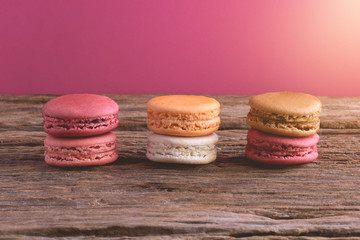 Different types color of macaroons on Old grunge wooden background