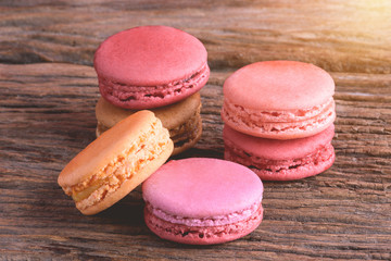 Different types color of macaroons on Old grunge wooden background