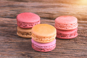 Different types color of macaroons on Old grunge wooden background