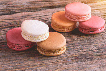 Different types color of macaroons on Old grunge wooden background