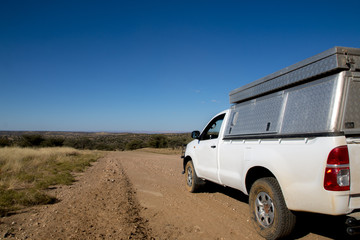 Fototapeta na wymiar Camping Car on Gravel Road in Namibia