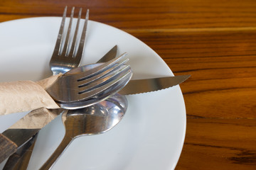 Empty plate with crossed fork and knife