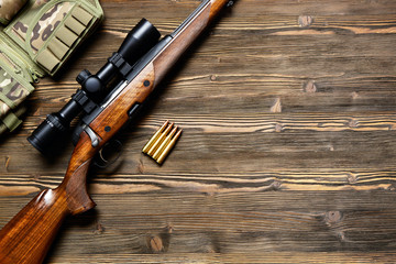 Hunting equipment on old wooden background.
