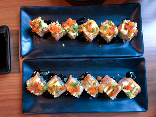 Sushi roll japanese food on black plate