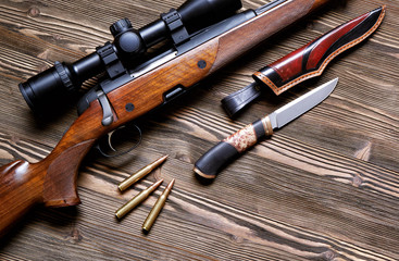 Hunting equipment on old wooden background.