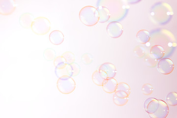 Abstract pink soap bubbles floating in the air.