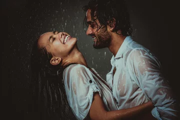Fotobehang Couple sharing romantic moments under the rain © oneinchpunch