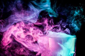 A glass with colorful smoke