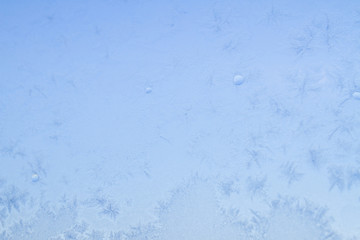 Winter frosty patterns on the frozen ice window