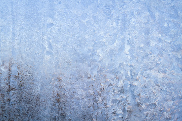Winter frosty patterns on the frozen ice window