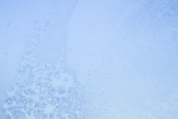 Winter frosty patterns on the frozen ice window