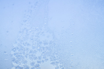 Winter frosty patterns on the frozen ice window