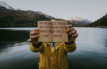 Explorer traveler with his diary on the lakeside