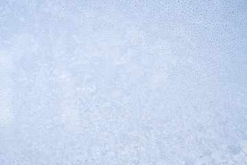 Winter frosty patterns on the frozen ice window