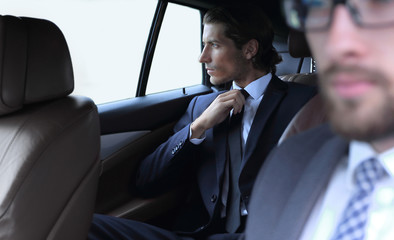 business people sitting in car