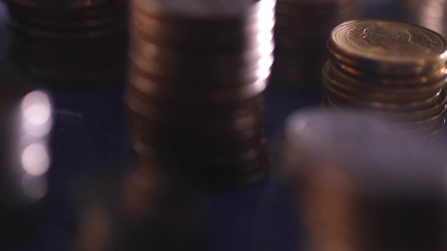 Close up money coin stacking on  the floor in dark light , the business and financial for money saving or investment background concept  , extremely close up and shallow DOF