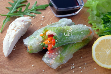 Spring rolls of chicken breast, bell pepper and cucumber wrapped in rice paper. Healthy food.
