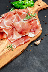 Italian prosciutto crudo or spanish jamon. Raw ham on wooden cutting board