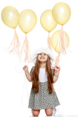Little girl is playing with a balloon