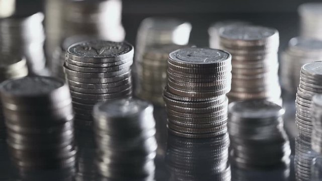 Close up money coin stacking on  the floor in dark light , the business and financial for money saving or investment background concept  , extremely close up and shallow DOF