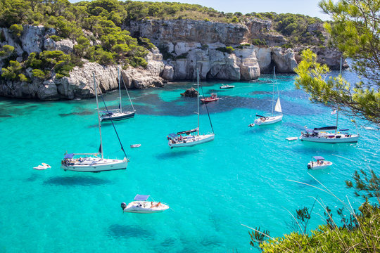 Fototapeta Boats and yachts on Macarella beach, Menorca, Spain