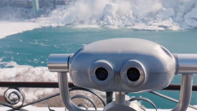 Niagara Falls without tourists in the winter season. A row of binoculars, no one is near