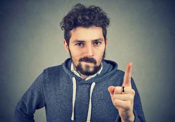 Young man threatening with finger